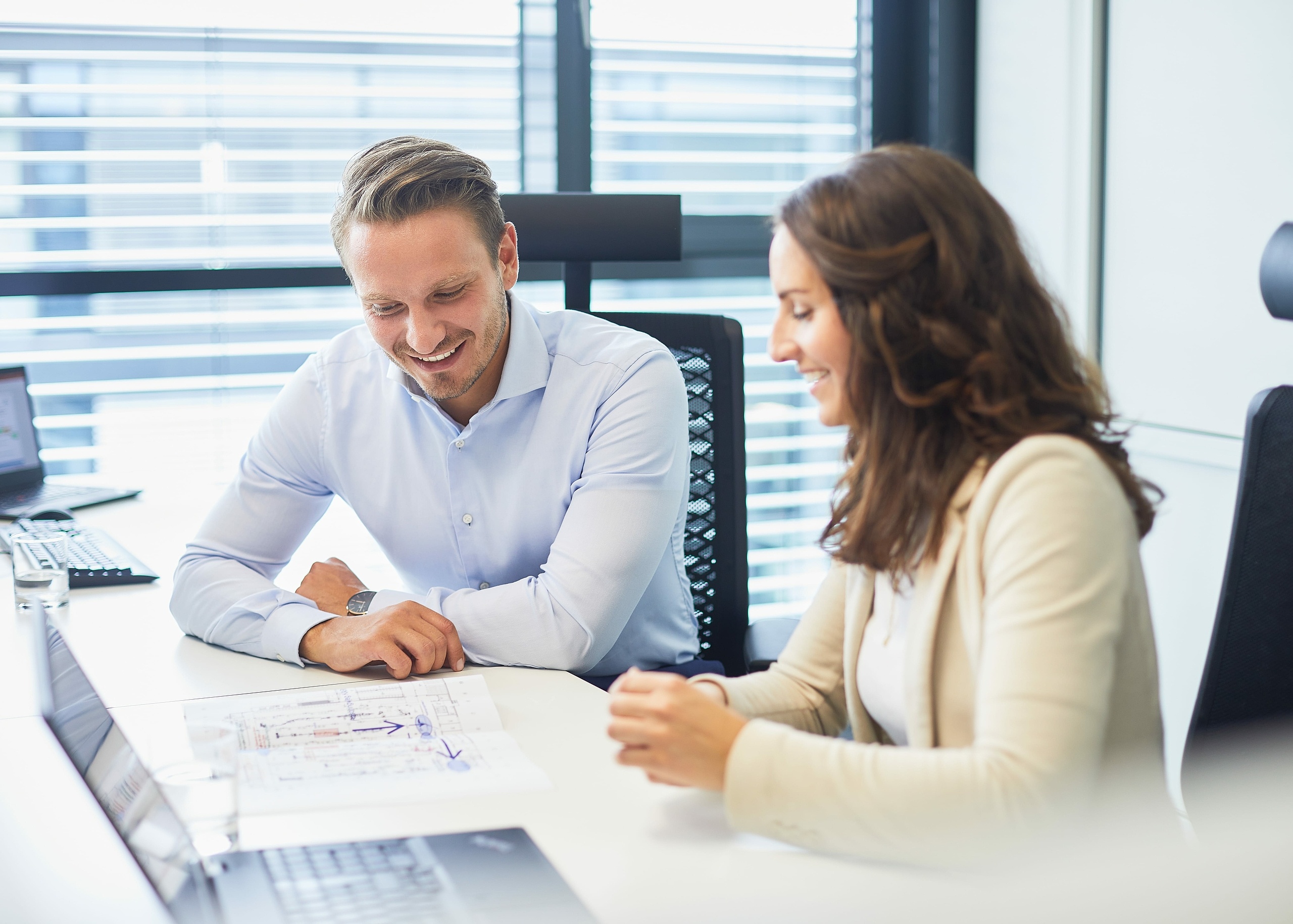 Colleagues working together at desk