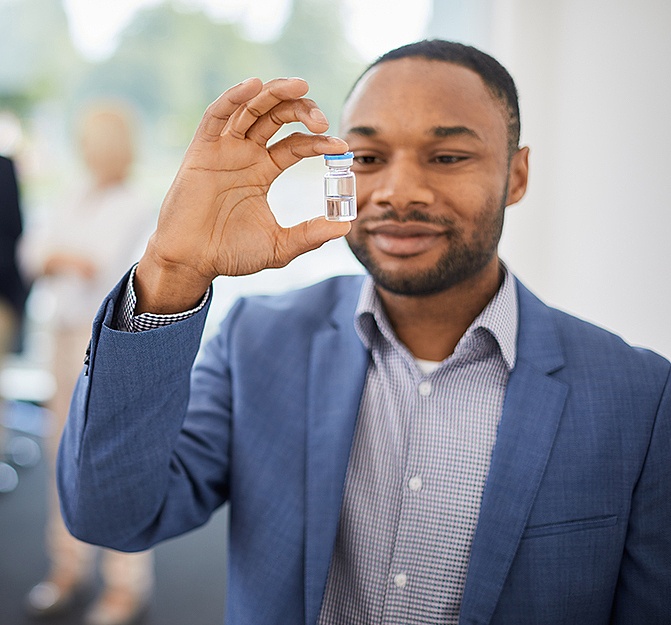 Man holding filled vial