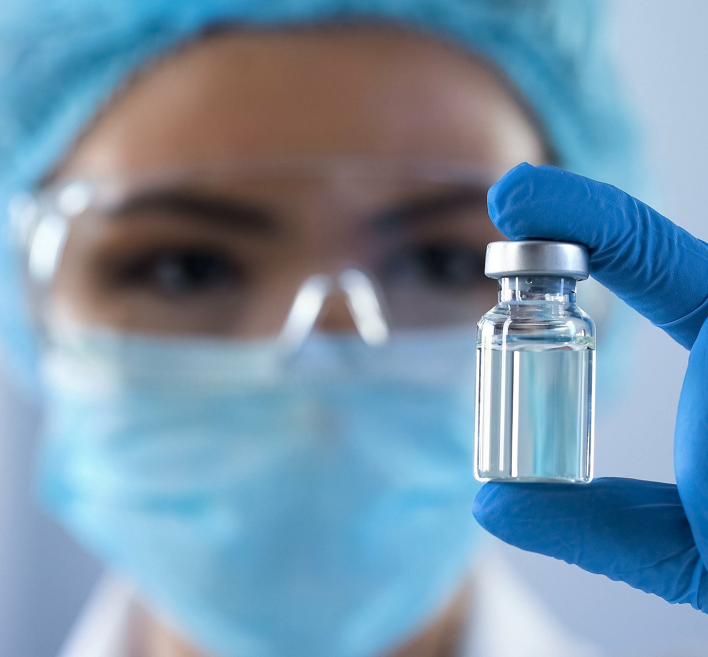 Woman in production controlling a vial