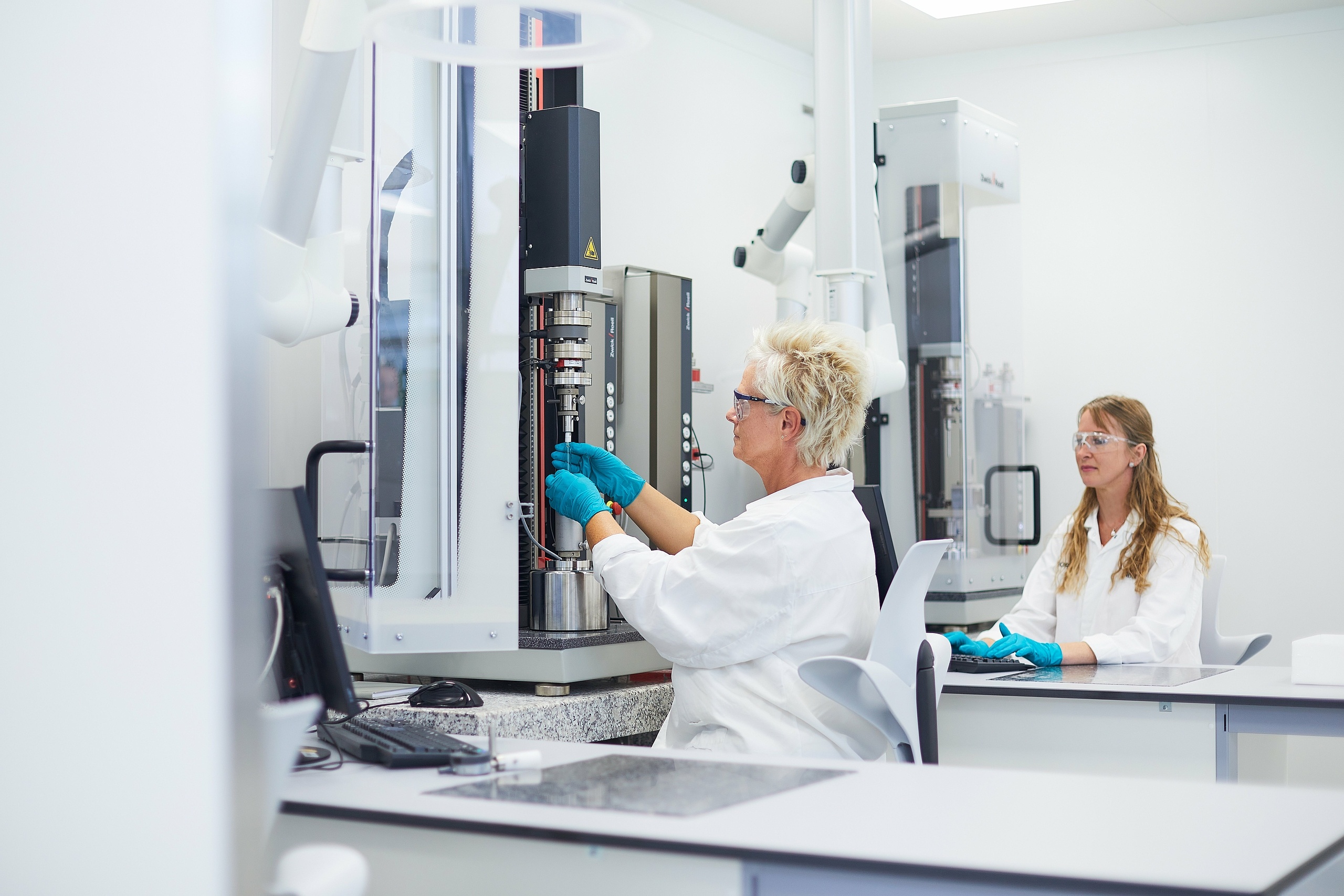 Two women are working in an analytical services lab. 